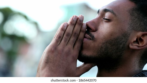 Spiritual-young-black-African-man-praying-to-GOD-Person-looking-to-sky-with-HOPE-and-FAITH-s1865442070